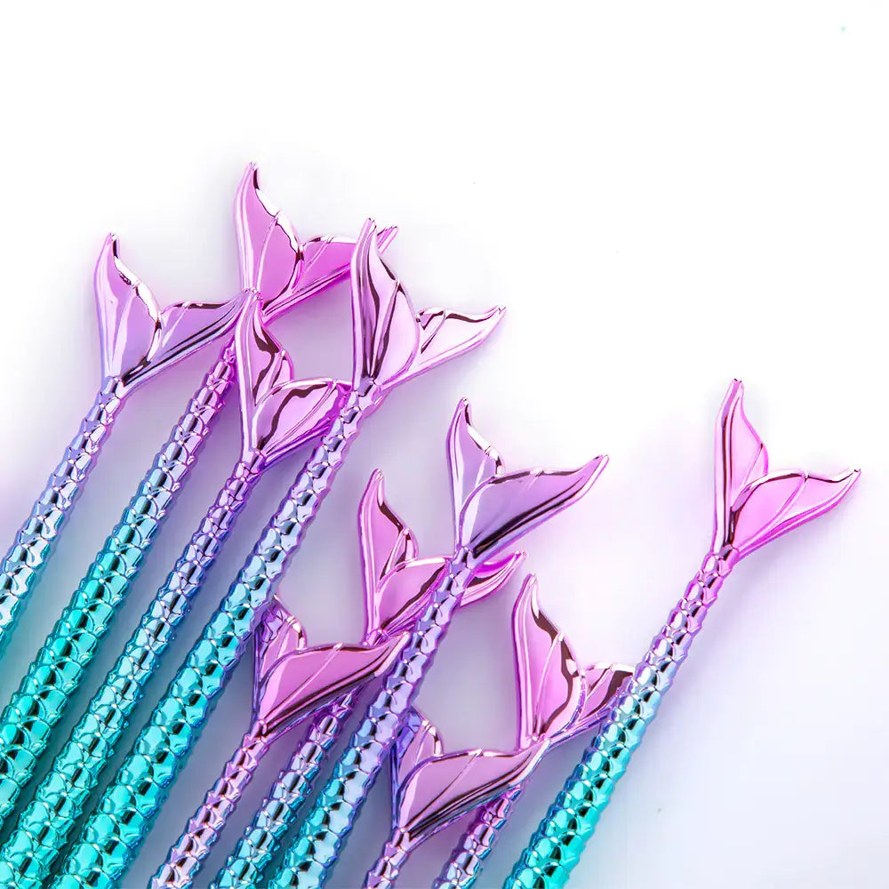 Colorful mermaid tail makeup brushes with gradient design in shades of purple and blue.